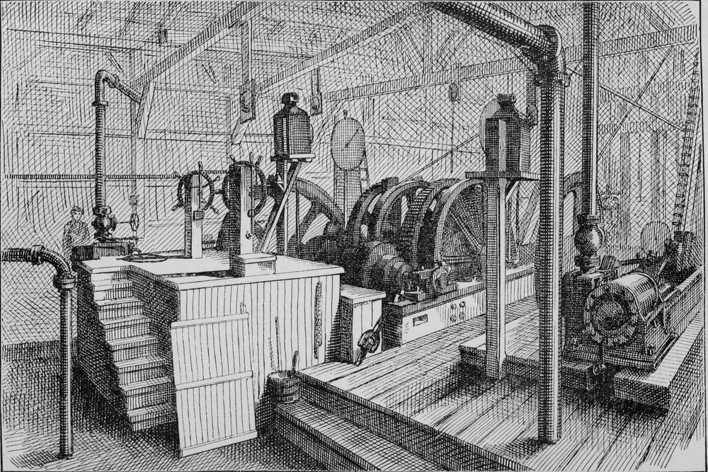 The inside of a large timber engine house: great geared winding drums, pipes, steering-wheel-like brake wheels and steam engines. A single worker stands at the far left.